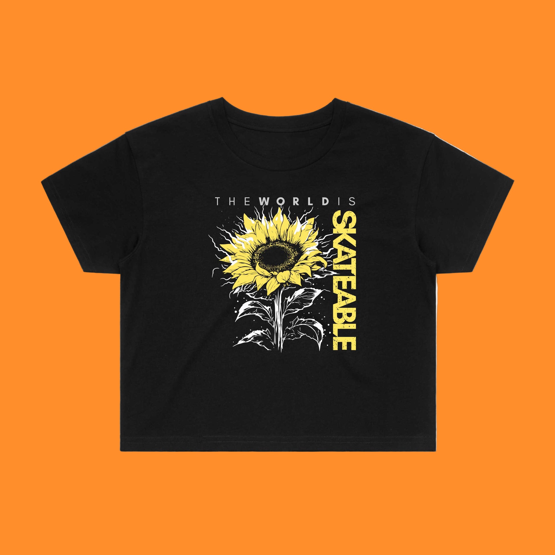 A black crop top featuring a large sunflower design with the text 'THE WORLDS IS SKATEABLE' across the chest.