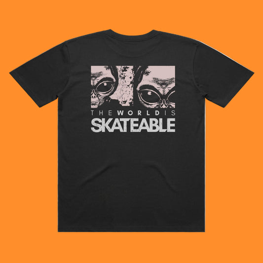 Black t-shirt with graphic design and text 'The World is Skateable' on a white background