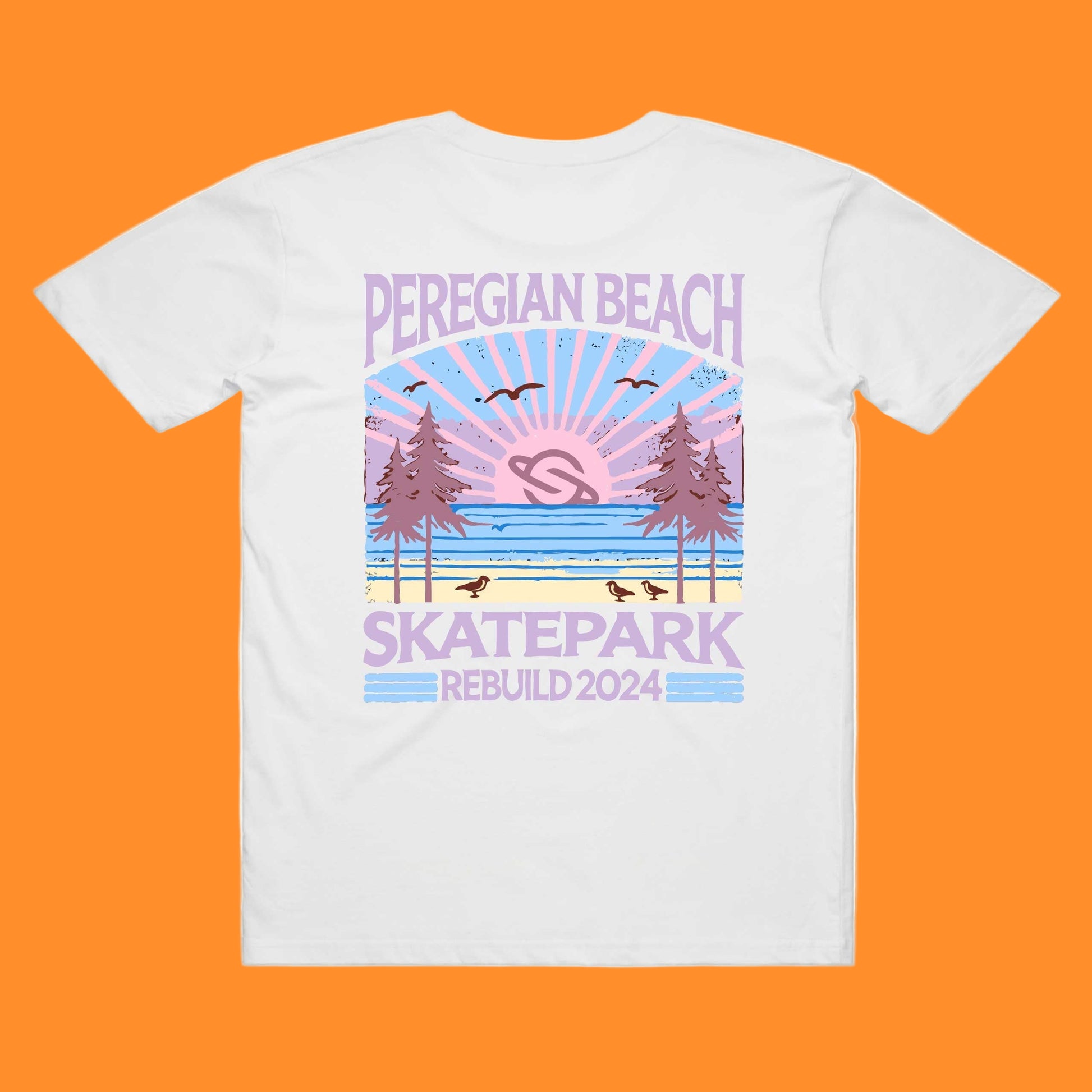 A white t-shirt with a printed design featuring the text 'PEREGIAN BEACH SKATEPARK' and a graphic of a sunset over a skatepark with birds and trees.