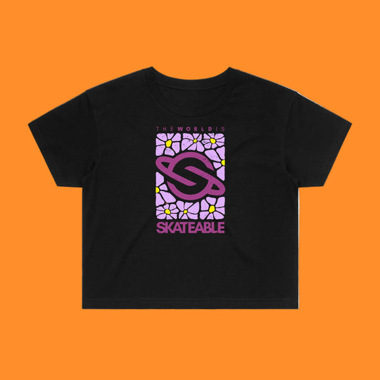 A black crop top with a purple floral pattern on the front, featuring the text 'skateable' in a stylized font.